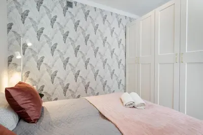 Łóżko lub łóżka w pokoju w obiekcie Olive Apartment Ochota