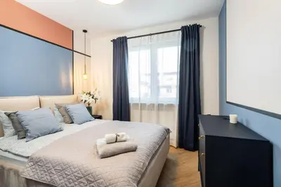 Łóżko lub łóżka w pokoju w obiekcie Deer Park Residence Mokotow