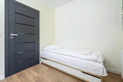 Łóżko lub łóżka w pokoju w obiekcie ShortStayPoland Wileńska B165