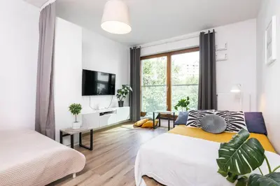 Łóżko lub łóżka w pokoju w obiekcie Riverside Residence Port Praski