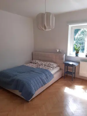 Łóżko lub łóżka w pokoju w obiekcie Karmel Apartment