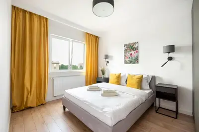 Łóżko lub łóżka w pokoju w obiekcie Wileńska Express Homely Apartment by BookingHost
