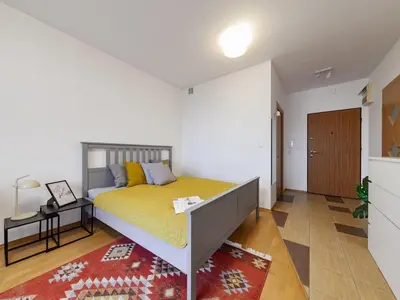 Łóżko lub łóżka w pokoju w obiekcie Etno Chic Studio Ursynow