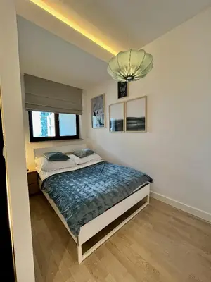 Łóżko lub łóżka w pokoju w obiekcie Apartament NiePokorny