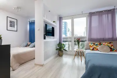 Łóżko lub łóżka w pokoju w obiekcie Lavender Studios City Centre Grzybowska
