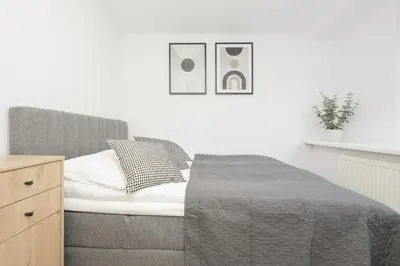 Łóżko lub łóżka w pokoju w obiekcie Elegant Grey Apartment Wspólna Śródmieście in Warsaw by Noclegi Renters