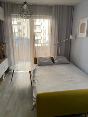 Łóżko lub łóżka w pokoju w obiekcie West Station Apartment
