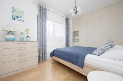 Łóżko lub łóżka w pokoju w obiekcie Klimatyzowany Apartament w Stolicy by Noclegi Renters