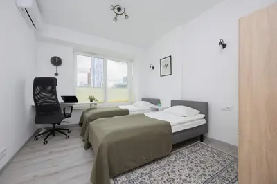 Łóżko lub łóżka w pokoju w obiekcie Apartament z Widokiem na Centrum 9 Piętro & Parking by Noclegi Renters