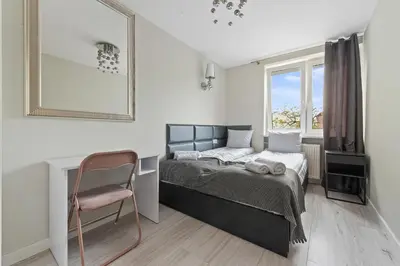 Łóżko lub łóżka w pokoju w obiekcie RentPlanet - Apartament Mokotowska