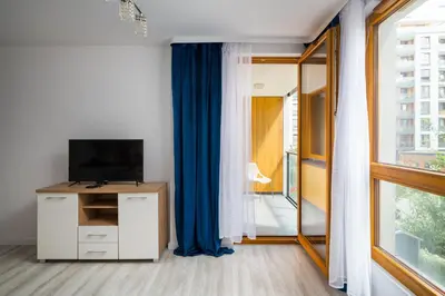 Telewizja i/lub zestaw kina domowego w obiekcie Wola Pleasant Apartment by BookingHost