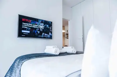 Łóżko lub łóżka w pokoju w obiekcie MENNICA RESIDENCE PATRONUS Apartments