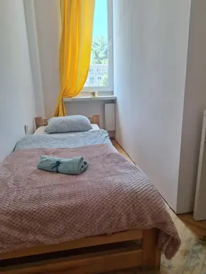 Łóżko lub łóżka w pokoju w obiekcie Regem Aleja Solidarności