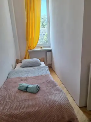 Łóżko lub łóżka w pokoju w obiekcie Regem Aleja Solidarności