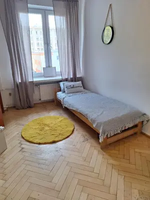 Łóżko lub łóżka w pokoju w obiekcie Regem Aleja Solidarności