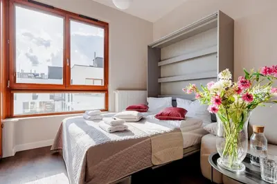 Łóżko lub łóżka w pokoju w obiekcie Bright Studio in Mokotów Business Center