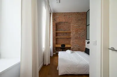 Łóżko lub łóżka w pokoju w obiekcie Park Praski Two-Level Apartment by BookingHost