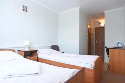 Łóżko lub łóżka w pokoju w obiekcie Dobre Miejsce Dom Rekolekcyjny