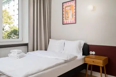 Łóżko lub łóżka w pokoju w obiekcie Hala Mirowska Spacious Apartment by BookingHost
