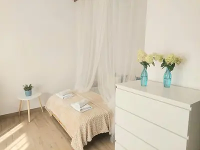 Łóżko lub łóżka w pokoju w obiekcie Rental Apartments Smoluchowskiego