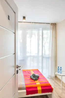 Łóżko lub łóżka w pokoju w obiekcie Apart Rooms City Centr