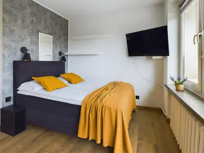 Łóżko lub łóżka w pokoju w obiekcie Bright Studio in Downtown Warsaw by Noclegi Renters