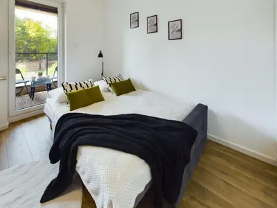 Łóżko lub łóżka w pokoju w obiekcie Klimatyczne Studio z Balkonem Warszawa by Noclegi Renters
