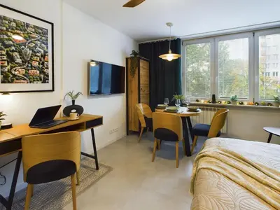 Łóżko lub łóżka w pokoju w obiekcie Atmospheric Studio for 3 People in Warsaw with Desk for Remote Work by Noclegi Renters