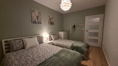 Łóżko lub łóżka w pokoju w obiekcie Apartament Dębowe Zacisze Tużycka