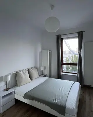 Łóżko lub łóżka w pokoju w obiekcie Modern Zoliborz Apartment
