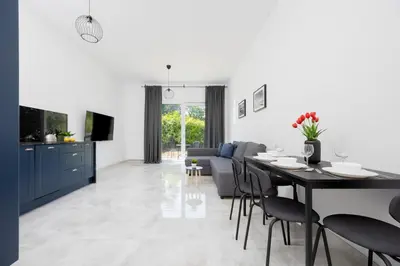 Telewizja i/lub zestaw kina domowego w obiekcie Wyjątkowy Apartament z Uroczym Ogródkiem oraz Parkingiem by Noclegi Renters