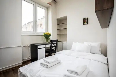 Łóżko lub łóżka w pokoju w obiekcie Apartamenty Wawa Centrum by Your Freedom