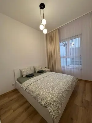 Łóżko lub łóżka w pokoju w obiekcie MaxApart Apartament Wiktoryn