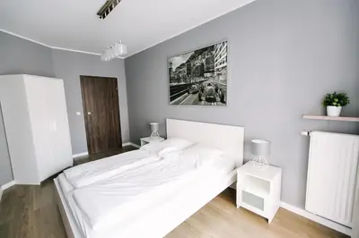 Łóżko lub łóżka w pokoju w obiekcie RENTTNER Apartamenty