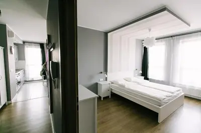 Łóżko lub łóżka w pokoju w obiekcie RENTTNER Apartamenty