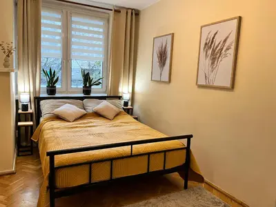 Łóżko lub łóżka w pokoju w obiekcie OhMyHome-Plac Zawiszy