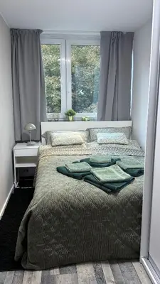 Łóżko lub łóżka w pokoju w obiekcie Apartament Grzybowska