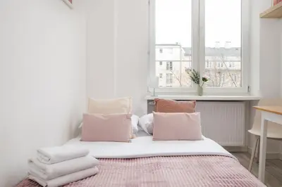 Łóżko lub łóżka w pokoju w obiekcie Tamka Powiśle Pink Studio by BookingHost