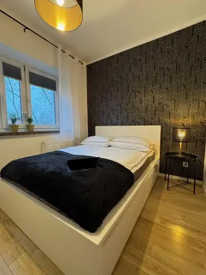 Łóżko lub łóżka w pokoju w obiekcie Nowolipie 16, City Center Apartment