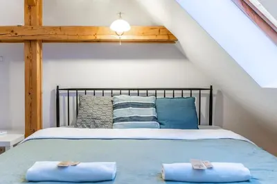 Łóżko lub łóżka w pokoju w obiekcie Warsaw Concierge Podwale