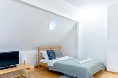 Łóżko lub łóżka w pokoju w obiekcie Warsaw Concierge Podwale