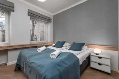 Łóżko lub łóżka w pokoju w obiekcie Garbarska 7 by Homeprime