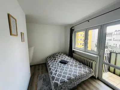 Łóżko lub łóżka w pokoju w obiekcie Wola Ratusz Rooms