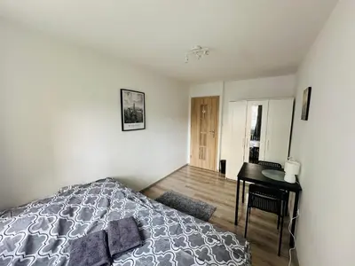 Łóżko lub łóżka w pokoju w obiekcie Wola Ratusz Rooms