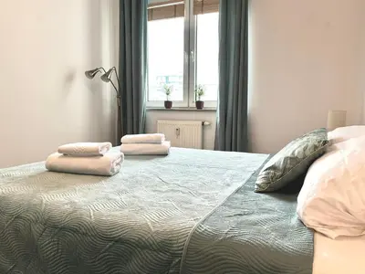 Łóżko lub łóżka w pokoju w obiekcie Real Life Apartament
