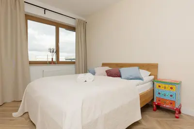 Łóżko lub łóżka w pokoju w obiekcie Stylish Apartment Zdziechowskiego with Parking & Home Office by Noclegi Renters
