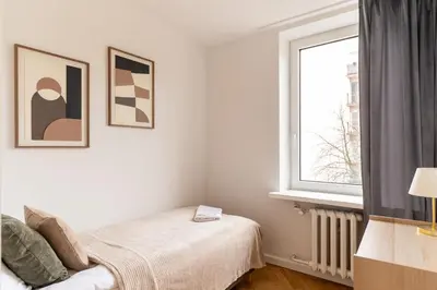 Łóżko lub łóżka w pokoju w obiekcie Warsaw Concierge Lipowa