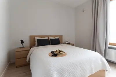 Łóżko lub łóżka w pokoju w obiekcie Stylowy Apartament przy Metrze, przy Centrum Onkologii