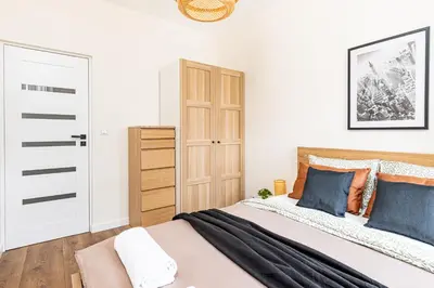 Łóżko lub łóżka w pokoju w obiekcie SuperApart Mińska Apt 27 - Przy Parku Skaryszewskim