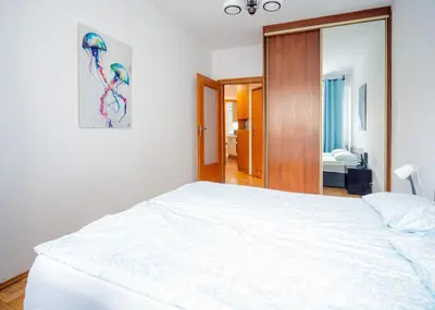 Łóżko lub łóżka w pokoju w obiekcie Green Kabaty Apartment 1